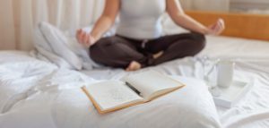 Mental health care, positive thinking, wellness. Woman in bed, practicing stress relief challenge